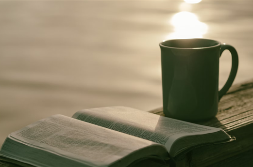 coffee mug and open bible